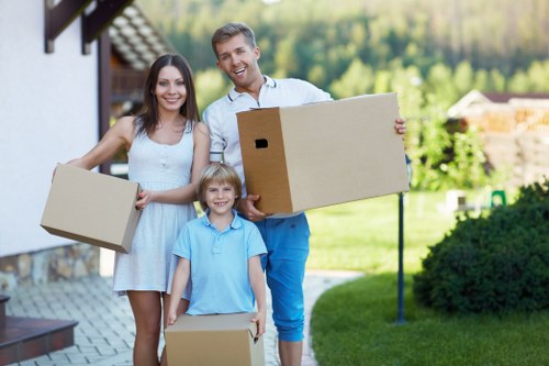Packed moving boxes labelled by room in a Dulwich property