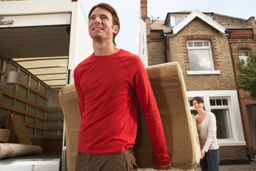 Mover handling furniture carefully during a house move service